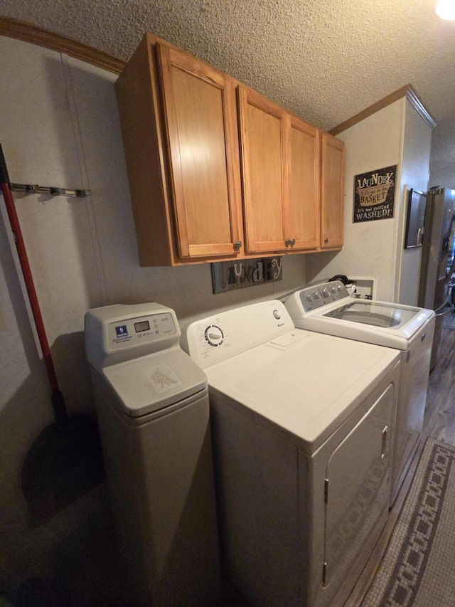 274 Pioneer St, Mendon, MI 49072 - laundry room featuring washer and clothes dryer, cabinet space, a textured ceiling, dark wood-style floors, and ornamental molding