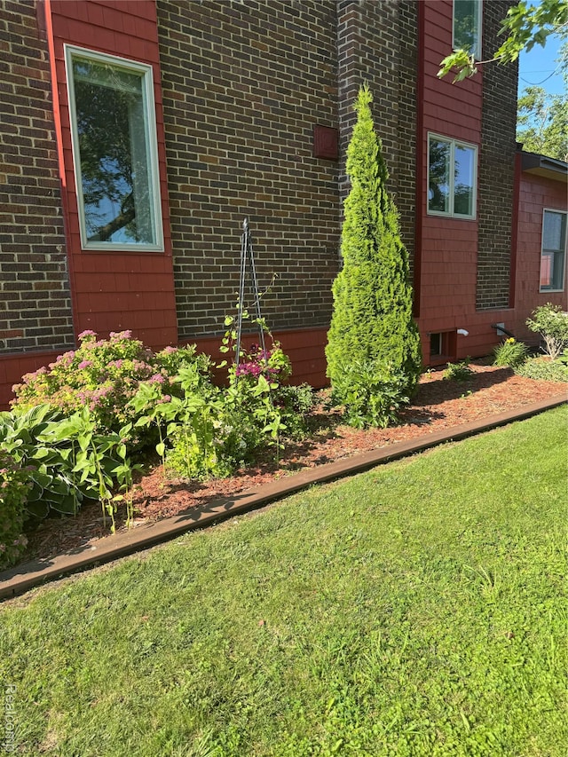 3981 Orchard Rd, Peck, MI 48466 - view of home's exterior featuring brick siding and a yard