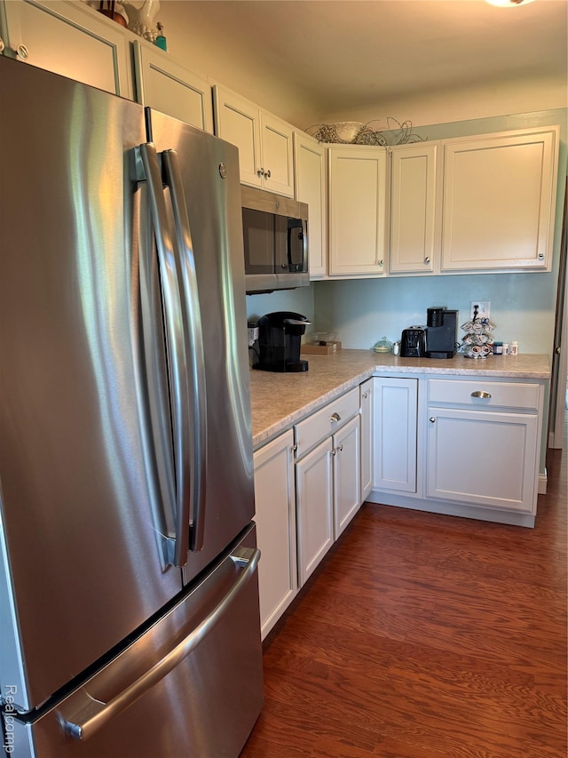 3981 Orchard Rd, Peck, MI 48466 - kitchen featuring appliances with stainless steel finishes, light countertops, dark wood-type flooring, and white cabinetry
