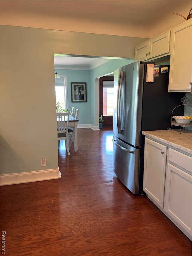 3981 Orchard Rd, Peck, MI 48466 - kitchen featuring arched walkways, freestanding refrigerator, white cabinetry, dark wood finished floors, and light countertops