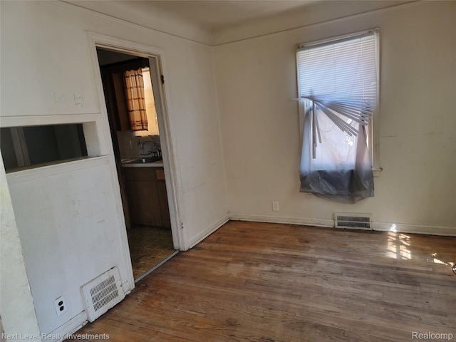 8850 Farmbrook St, Detroit, MI 48236 - spare room with wood finished floors and baseboards