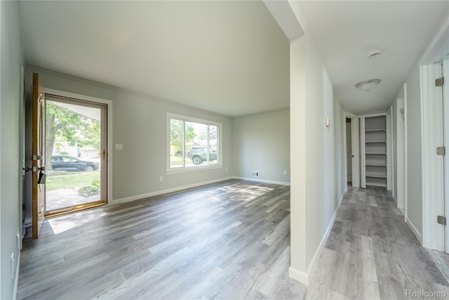 6448 Hunter Ct, Westland, MI 48185 - unfurnished living room featuring wood finished floors and baseboards