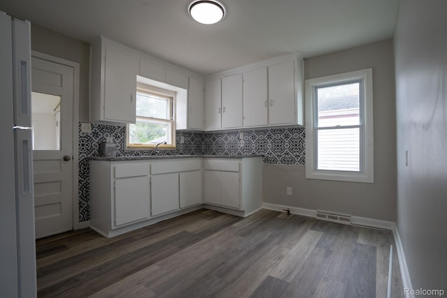 23199 Stewart Ave, Warren, MI 48089 - kitchen featuring white cabinetry and wood finished floors