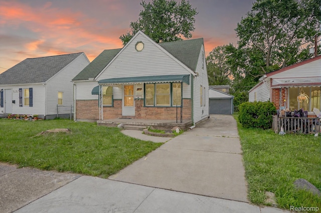 23199 Stewart Ave, Warren, MI 48089 - view of front of property with an outbuilding, brick siding, and a yard