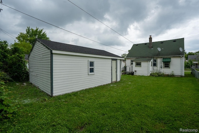 23199 Stewart Ave, Warren, MI 48089 - rear view of property with a yard, an outbuilding, and a chimney