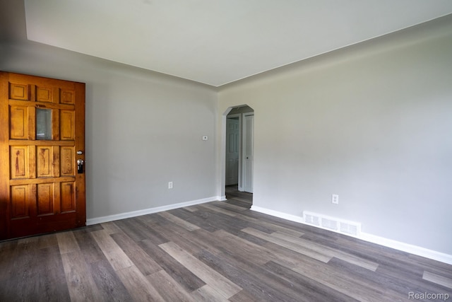 23199 Stewart Ave, Warren, MI 48089 - unfurnished room featuring arched walkways and dark wood finished floors