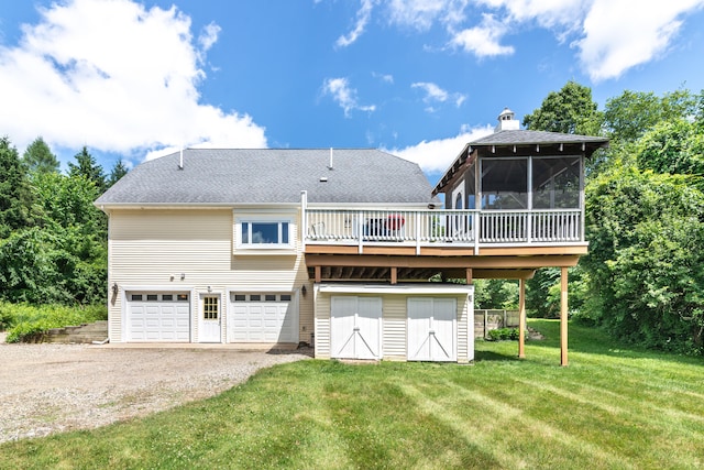 8150 Mester Rd, Chelsea, MI 48118 - rear view of property with a deck, driveway, a sunroom, a garage, and a lawn