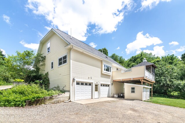 8150 Mester Rd, Chelsea, MI 48118 - view of side of home with driveway and an attached garage