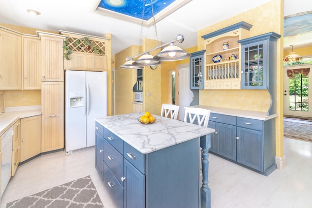 8150 Mester Rd, Chelsea, MI 48118 - kitchen with white fridge with ice dispenser, a skylight, blue cabinets, a center island, and glass insert cabinets