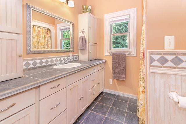 8150 Mester Rd, Chelsea, MI 48118 - bathroom with vanity, tile patterned flooring, and backsplash