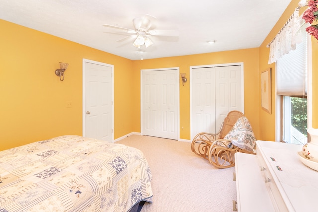 8150 Mester Rd, Chelsea, MI 48118 - bedroom featuring multiple closets, light carpet, and a ceiling fan
