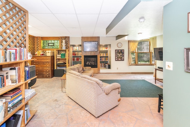 8150 Mester Rd, Chelsea, MI 48118 - living room with a tiled fireplace and a drop ceiling