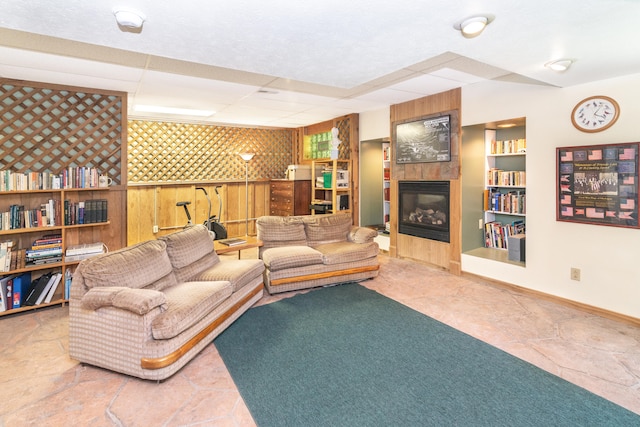 8150 Mester Rd, Chelsea, MI 48118 - living room featuring a tile fireplace, wooden walls, and built in features