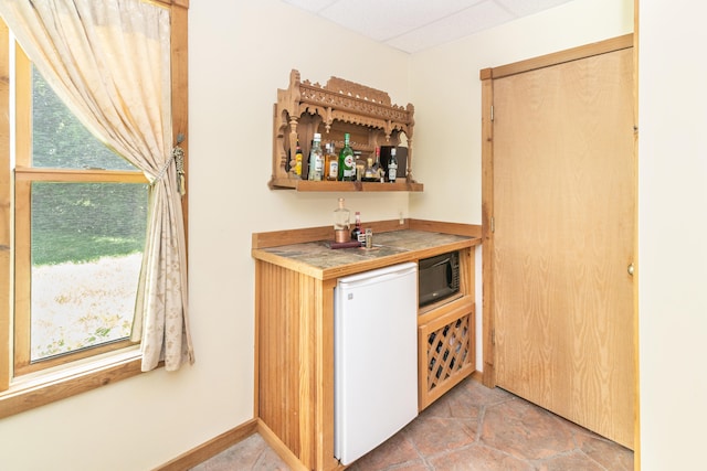 8150 Mester Rd, Chelsea, MI 48118 - indoor dry bar featuring black microwave and refrigerator