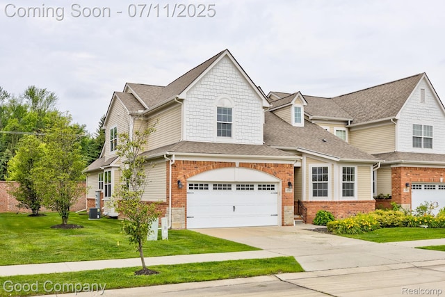 4361 Bennett Park Cir, Troy, MI 48085 - view of front facade with concrete driveway, a front yard, brick siding, and a shingled roof