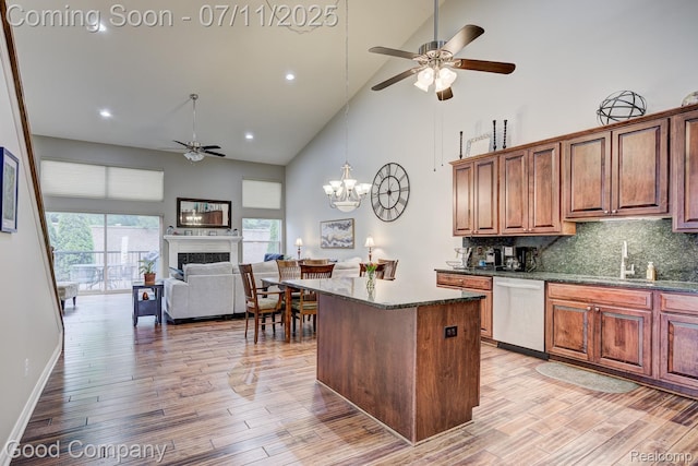 4361 Bennett Park Cir, Troy, MI 48085 - kitchen featuring stainless steel dishwasher, high vaulted ceiling, ceiling fan, a center island, and a fireplace