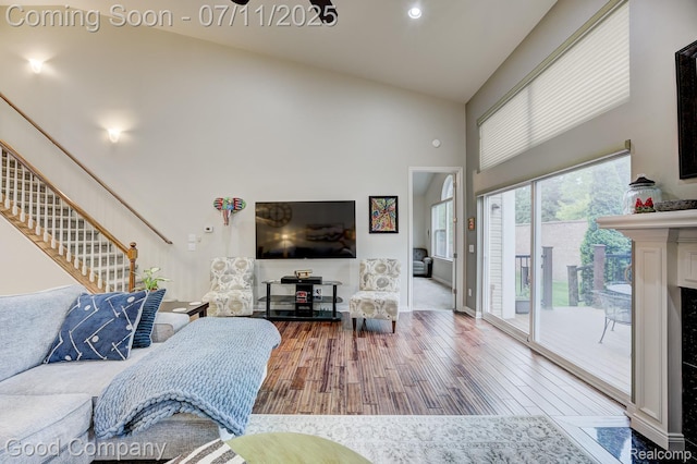 4361 Bennett Park Cir, Troy, MI 48085 - living room featuring high vaulted ceiling, stairway, and wood finished floors