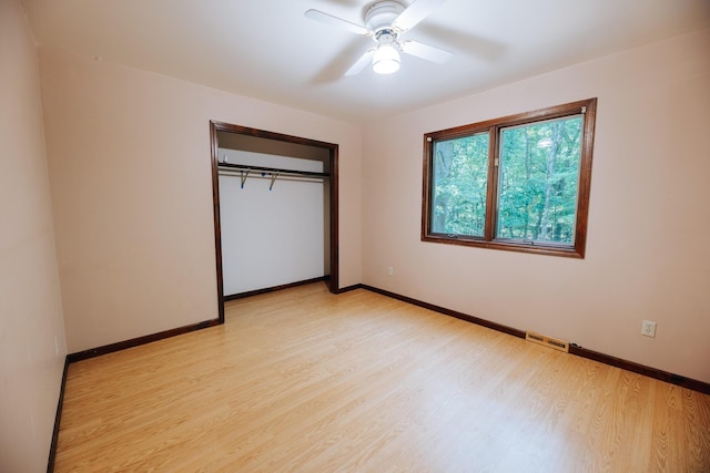 18400 N Fruitport Rd, Spring Lake, MI 49456 - unfurnished bedroom featuring light wood-style flooring, a closet, and a ceiling fan
