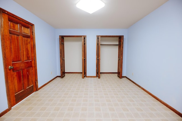 18400 N Fruitport Rd, Spring Lake, MI 49456 - unfurnished bedroom featuring multiple closets and light colored carpet