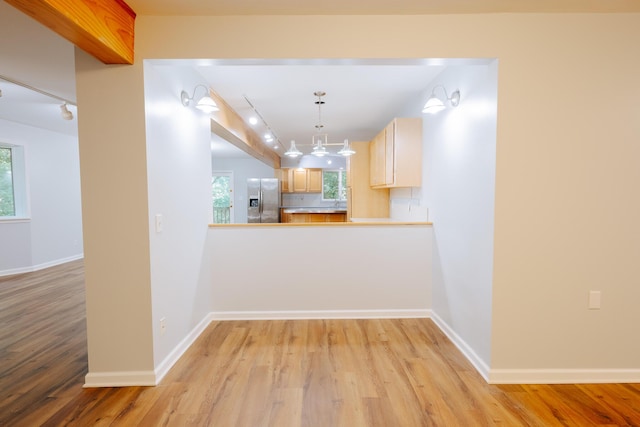18400 N Fruitport Rd, Spring Lake, MI 49456 - kitchen featuring stainless steel fridge, light wood finished floors, healthy amount of natural light, and light countertops