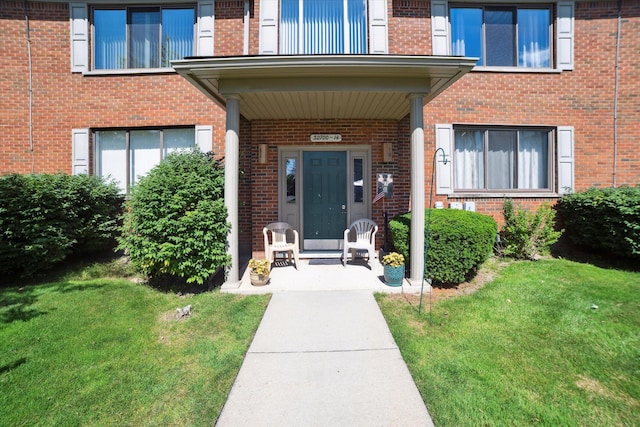 32708 Harper Ave Unit 5, Saint Clair Shores, MI 48082 - entrance to property with a lawn, brick siding, and a porch
