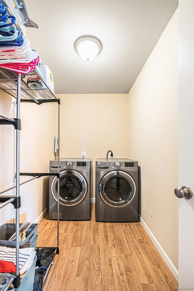 16621 Charles Town Ct, Linden, MI 48451 - washroom featuring separate washer and dryer and wood finished floors