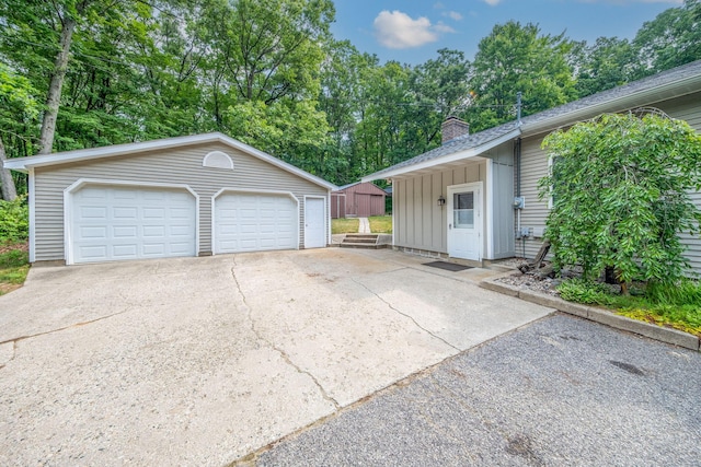 23974 Hooker Dr, Sand Lake, MI 49343 - detached garage featuring view of wooded area