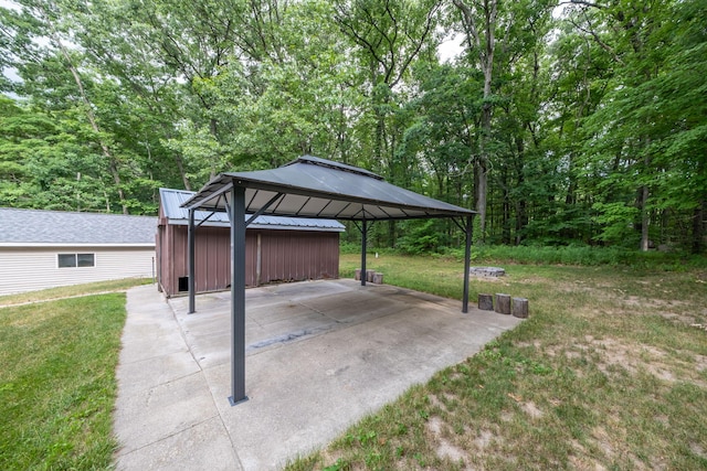 23974 Hooker Dr, Sand Lake, MI 49343 - view of patio with a gazebo, a carport, and a view of trees