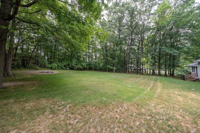 23974 Hooker Dr, Sand Lake, MI 49343 - view of green lawn featuring an outdoor fire pit