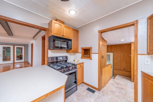 23974 Hooker Dr, Sand Lake, MI 49343 - kitchen featuring black microwave, stainless steel range with gas stovetop, light countertops, french doors, and beamed ceiling