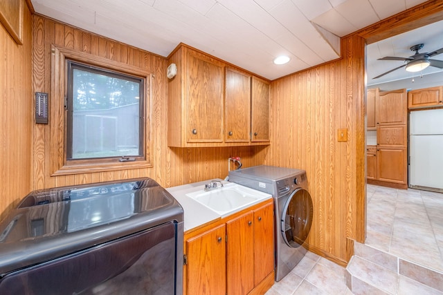 23974 Hooker Dr, Sand Lake, MI 49343 - laundry area featuring cabinet space, wooden walls, ceiling fan, and independent washer and dryer