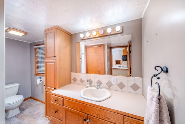 23974 Hooker Dr, Sand Lake, MI 49343 - bathroom with vanity, backsplash, and tile patterned floors