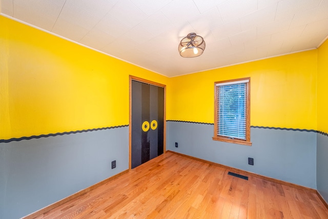 23974 Hooker Dr, Sand Lake, MI 49343 - unfurnished room featuring wood finished floors and ornamental molding