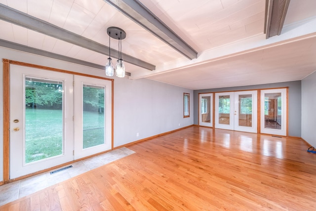 23974 Hooker Dr, Sand Lake, MI 49343 - spare room featuring healthy amount of natural light, french doors, wood finished floors, and beamed ceiling
