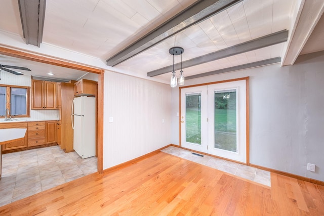 23974 Hooker Dr, Sand Lake, MI 49343 - unfurnished living room featuring beam ceiling, light wood-style floors, and a ceiling fan