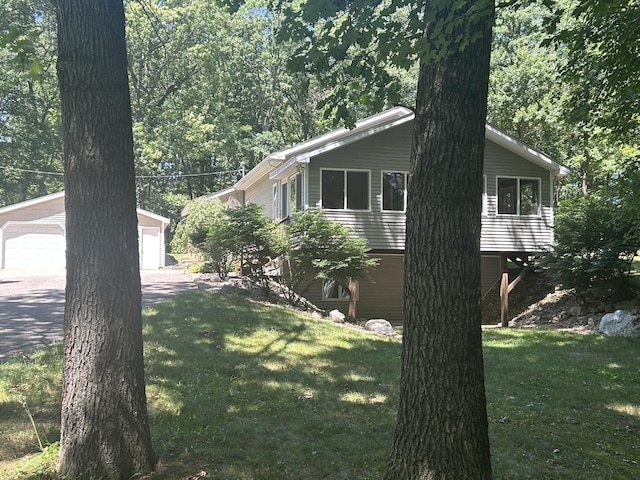 23974 Hooker Dr, Sand Lake, MI 49343 - view of home's exterior with an outdoor structure, a yard, and a garage