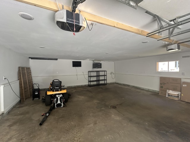 23974 Hooker Dr, Sand Lake, MI 49343 - garage featuring a garage door opener