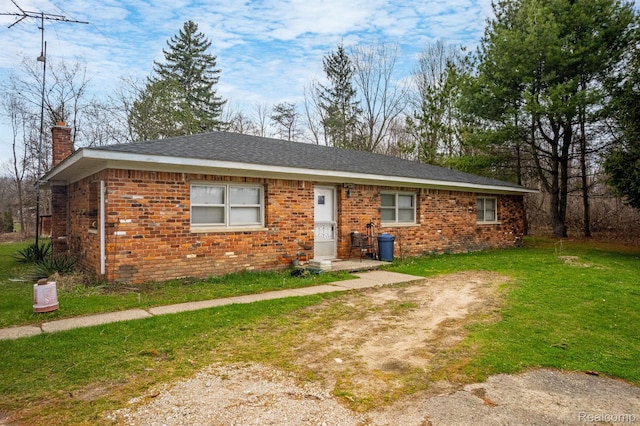 10685 Dixie Hwy, Davisburg, MI 48350 - view of front of home featuring a chimney, brick siding, and a front lawn