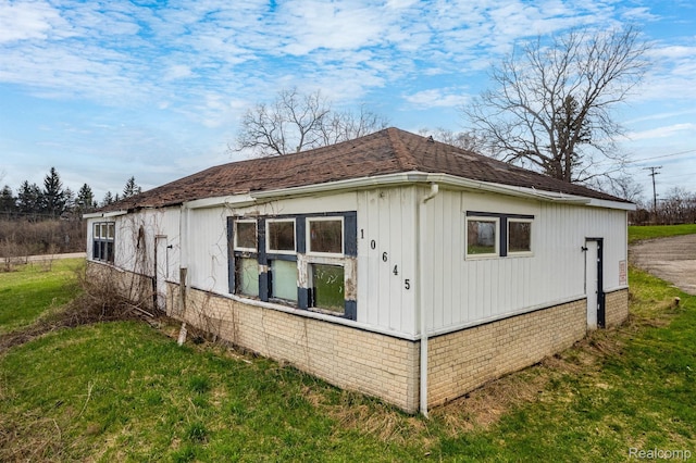 10685 Dixie Hwy, Davisburg, MI 48350 - view of home's exterior featuring a yard and a shingled roof
