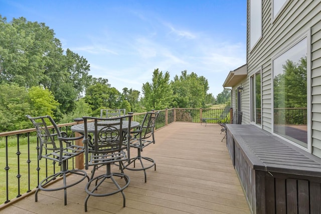 9752 Jackson Rd, Clarksville, MI 48815 - wooden terrace featuring view of scattered trees and outdoor dining area
