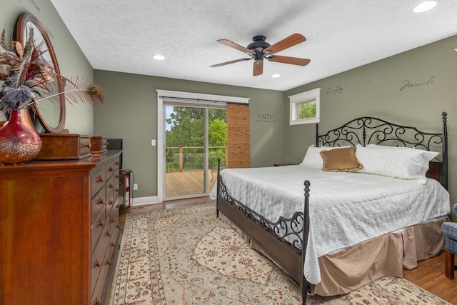 9752 Jackson Rd, Clarksville, MI 48815 - bedroom with access to outside, light wood-style floors, recessed lighting, a ceiling fan, and a textured ceiling