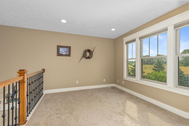 9752 Jackson Rd, Clarksville, MI 48815 - empty room featuring healthy amount of natural light, carpet, and recessed lighting