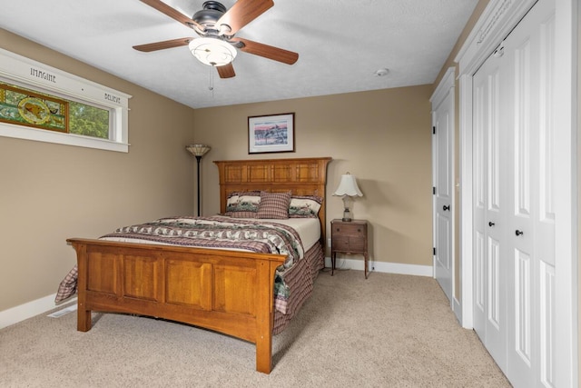 9752 Jackson Rd, Clarksville, MI 48815 - bedroom with light carpet, ceiling fan, and a closet