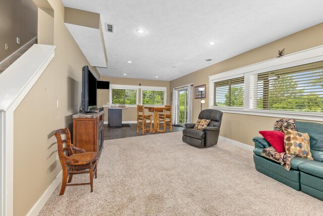 9752 Jackson Rd, Clarksville, MI 48815 - carpeted living area with recessed lighting and stairway