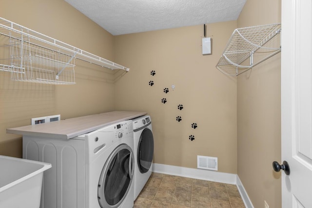9752 Jackson Rd, Clarksville, MI 48815 - washroom with washer and dryer and a textured ceiling