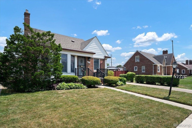8220 Hartwell St, Detroit, MI 48228 - view of front facade with a front lawn and brick siding