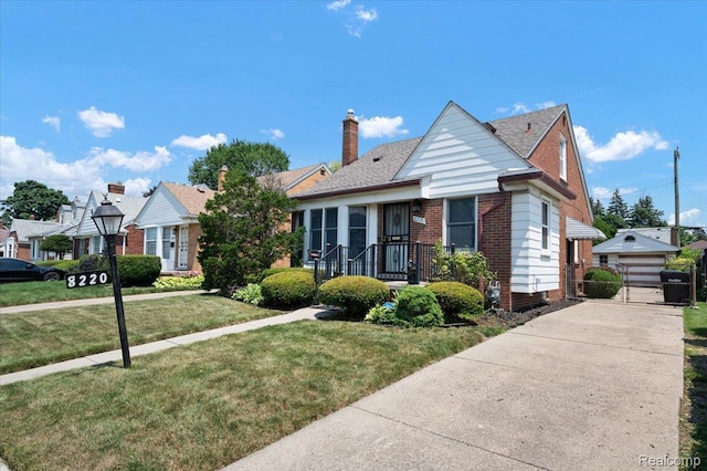 8220 Hartwell St, Detroit, MI 48228 - view of front facade with a gate, brick siding, and a chimney
