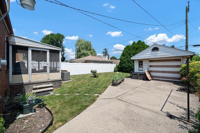 8220 Hartwell St, Detroit, MI 48228 - view of yard featuring a sunroom, a detached garage, an outbuilding, and entry steps