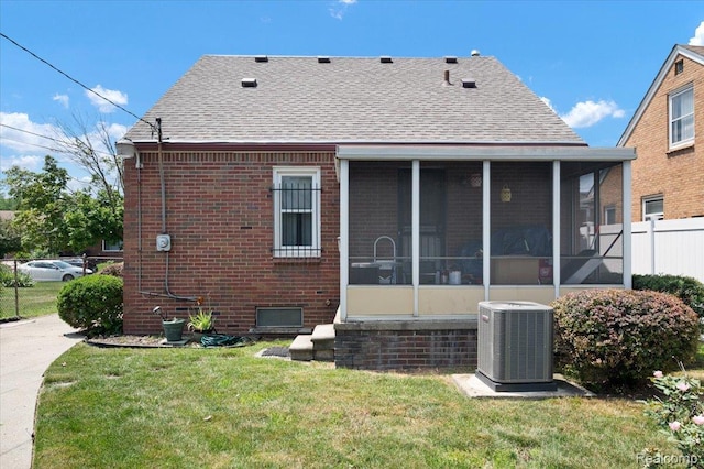 8220 Hartwell St, Detroit, MI 48228 - back of property featuring a sunroom, roof with shingles, and brick siding