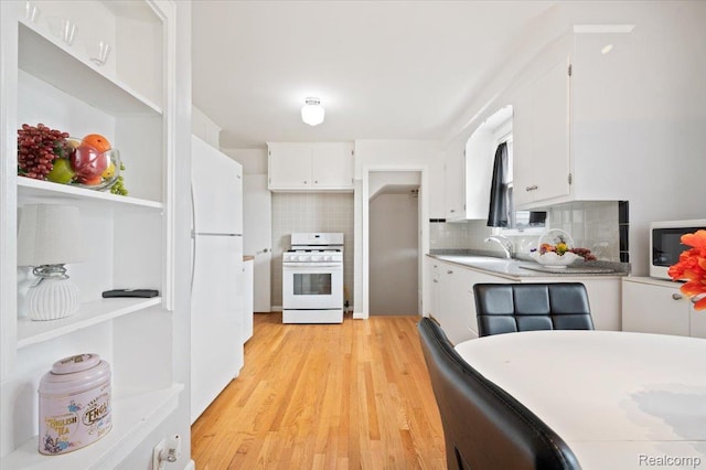 8220 Hartwell St, Detroit, MI 48228 - kitchen with white appliances, white cabinetry, tasteful backsplash, light wood finished floors, and light countertops